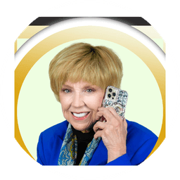 Dr. Jan Duffy, Las Vegas REALTOR, smiling on a phone call in a royal blue blazer, photographed for Grand Park Village Homes in West Summerlin, Las Vegas, Nevada. Shown at the top of the page.