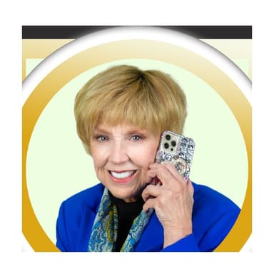 Dr. Jan Duffy, Las Vegas REALTOR, smiling on a phone call in a royal blue blazer, photographed for a Las Vegas home search in Las Vegas, Nevada. Shown with her note at the end of the page.